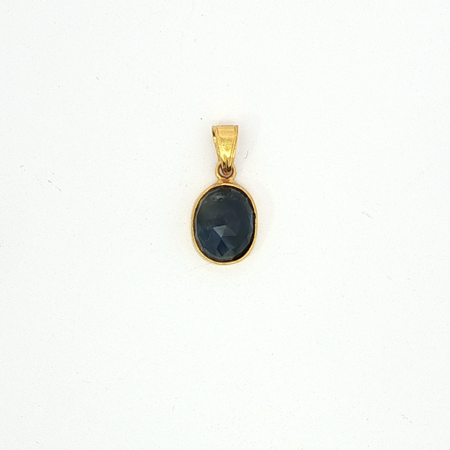 Deep Blue Sapphire Bezel Set in Yellow Gold