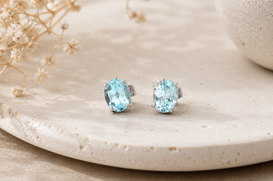 Oval Blue Topaz Stud Earrings in White Gold