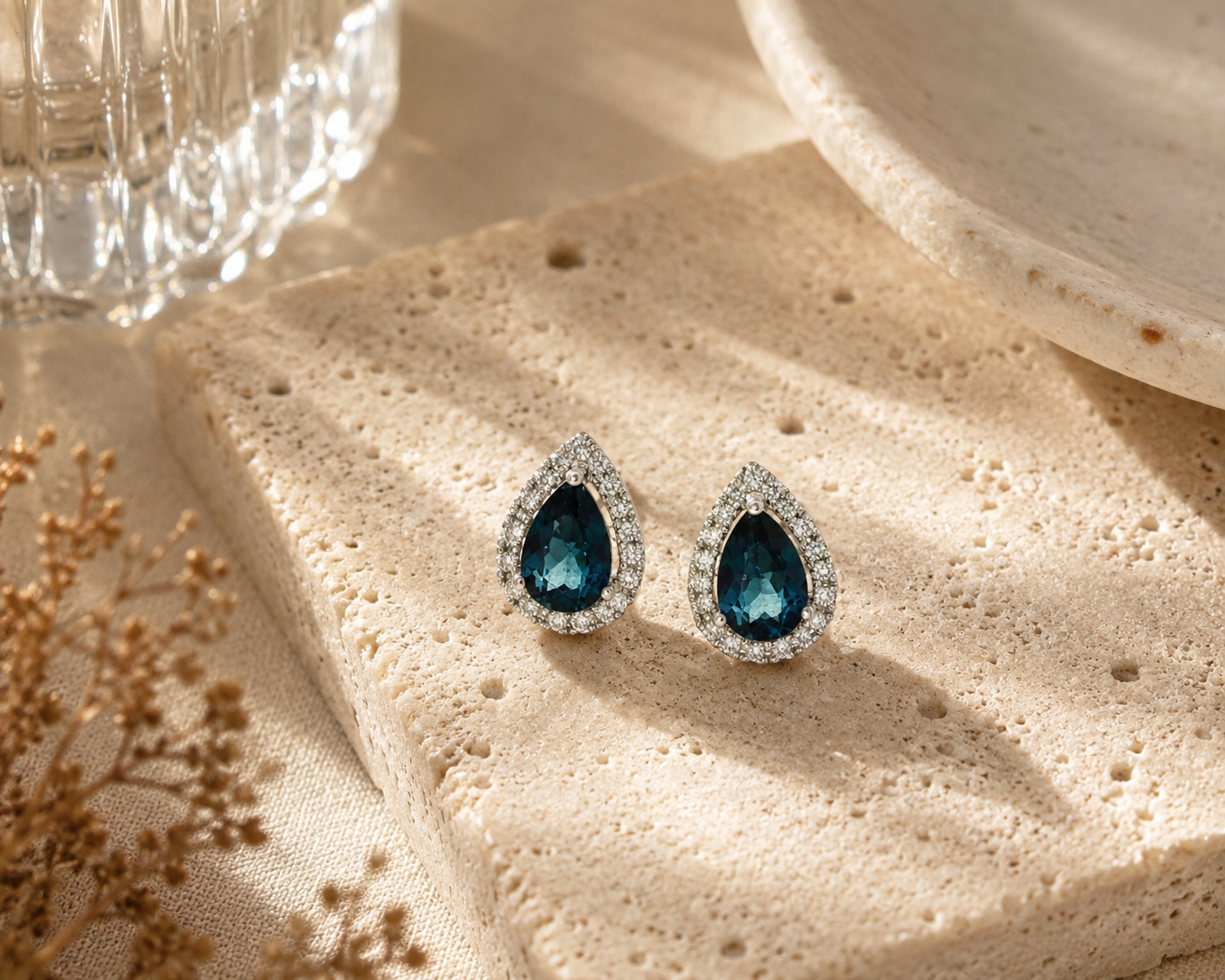 Deep Blue Pear Cut Sapphire and Diamond Halo Stud Earrings in White Gold